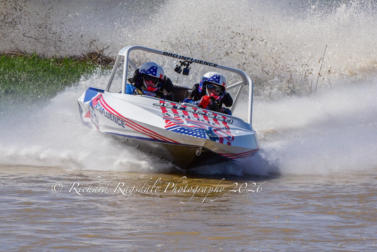 Sprint boat racing at speed through spray